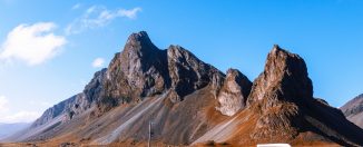 Voiture arrêtée devant une montagne pendant un roadtrip